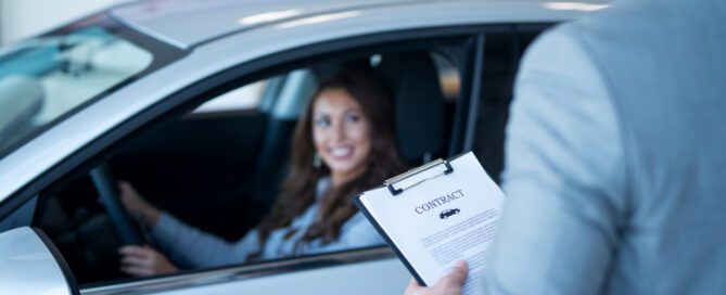 Customer finalizing car insurance agreement while sitting in vehicle in United States