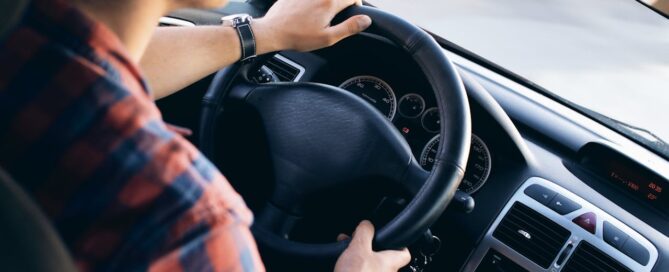 A man driving a car representing safety and car insurance coverage