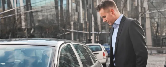 Businessman unlocking car, representing business insurance companies in NC